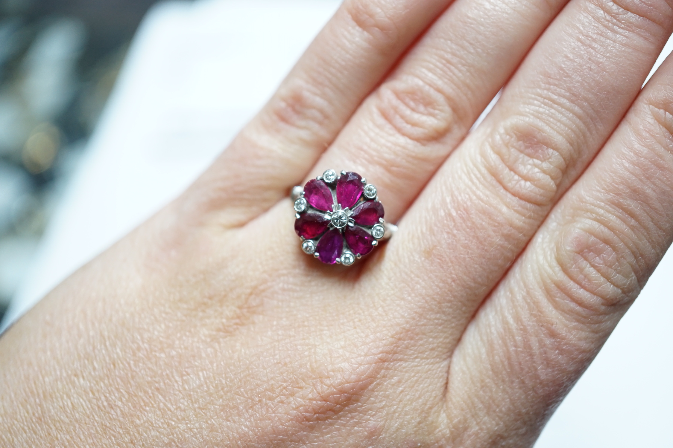 An 18ct & plat, pear cut ruby and diamond chip cluster set ring, size N/O, gross weight 4.8 grams.